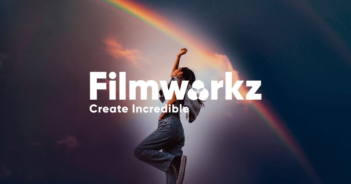 A person stands and raises one arm against the backdrop of a blue sky with a double rainbow. The text in bold white letters reads "Filmworkz Phoenix," with the subtitle "Create Incredible" below it.